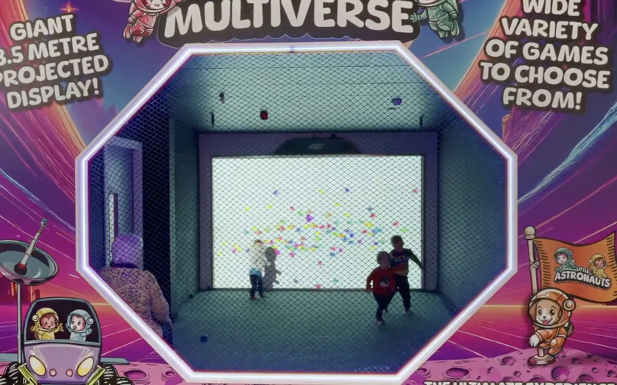 Two children playing a game on the Multiverse projected screen